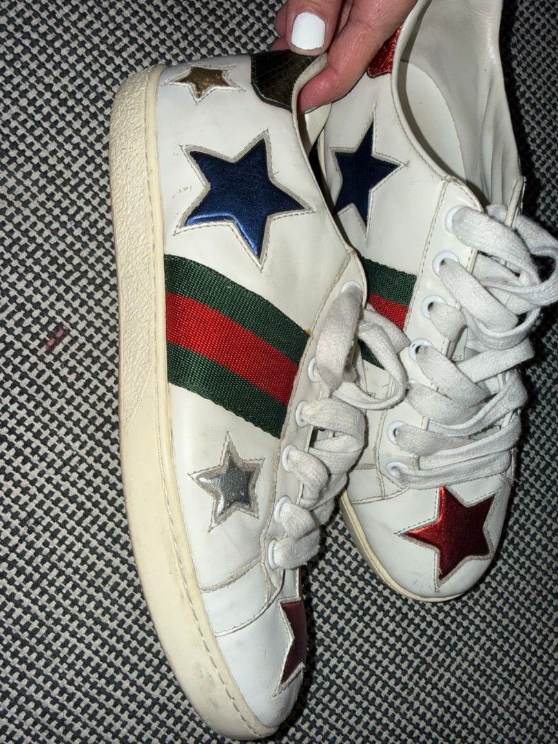 Gucci Star Ace Sneakers (Category: Sneakers) located in Makati City. Submitted by chris_angle (Listing ID 1426608573, Image 3). Description: Authentic Gucci Ace sneakers featuring a white leather upper with star appliqués. The iconic green and red stripe is visible on the sides. The heel tabs are in red and green with Gucci branding. The insoles are marked with "Gucci made in Italy". Meetup in Uptown Mall or Starbucks Avida Verte Shipping can be 