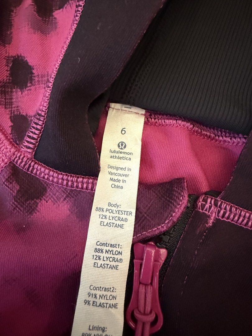 Lululemon Athletica Luon MD Jacket Size 6 (Category: Coats, Jackets and Outerwear) located in Muntinlupa City. Submitted by secondchancechic (Listing ID 1426654033, Image 2). Description: Lululemon Athletica jacket in size 6. Features a vibrant pink and black pattern with a full zip closure and hood. Made with Luon MD fabric. Includes thumbholes and double cuffs. The jacket has a slim fit and a long length. Designed in Vancouver and made in China