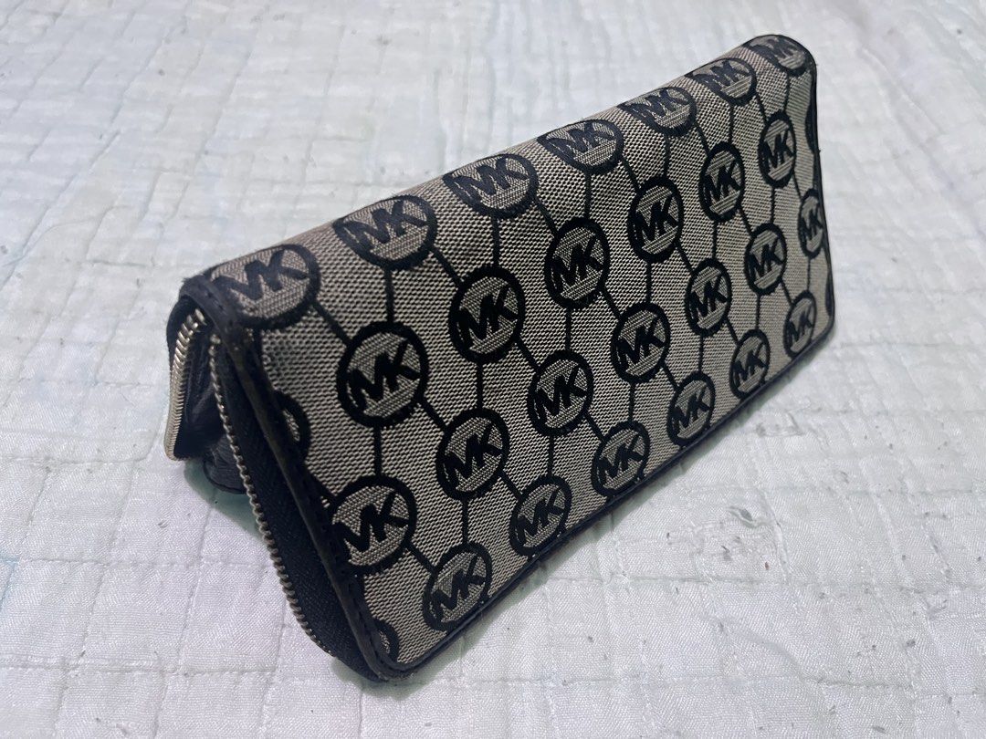 Michael Kors Monogram Wallet (Category: Luxury Bags & Wallets) located in Subic. Submitted by trashdimes2022 (Listing ID 1426739639, Image 3). Description: Please read first: Multi pocket wallet - Personal item (not thrifted) though has signs of usage. Mom’s preloved mk - Authentic, see pics for reference Dimension: 8 width x 4 Length (in inches) Condition: - Fading on plate stamp - stains (needs deep cleaning, has been stored for a long time) - 
