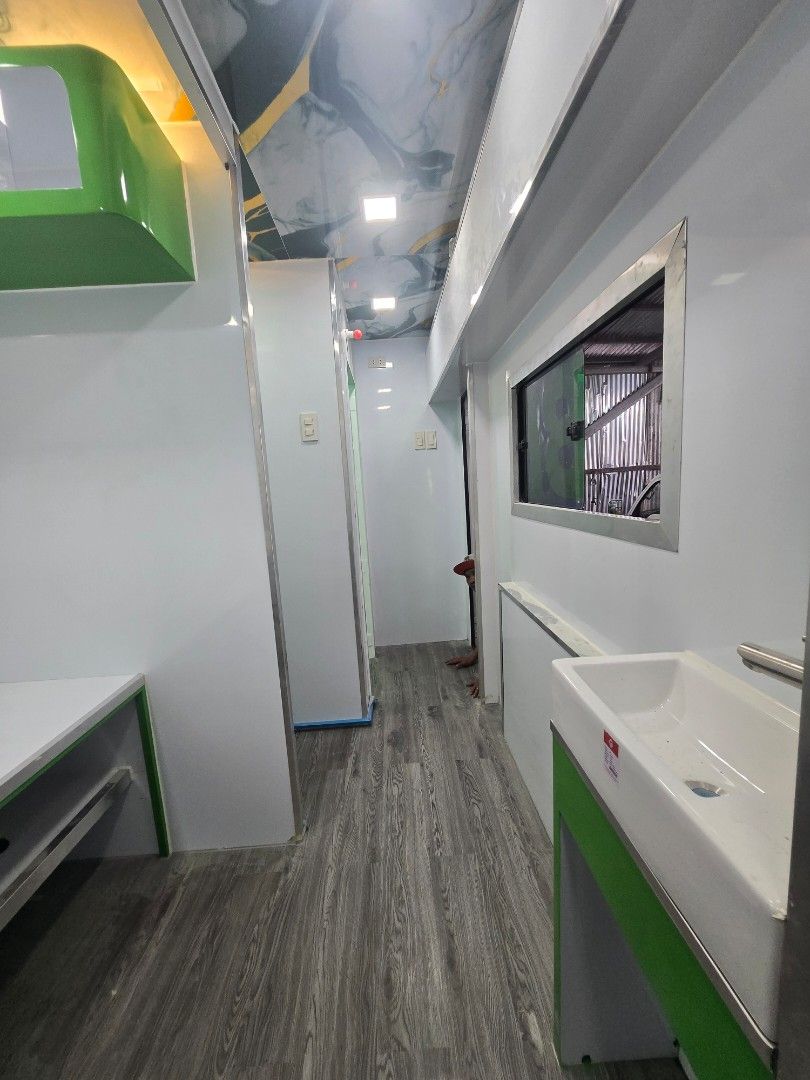 Mobile Clinic - Fully Equipped (Category: Commercial) located in Manila. Submitted by jonathanca24182 (Listing ID 1426790168, Image 3). Description: Mobile clinic with a modern interior design. Features include built-in cabinets, a sink, and ample lighting. The exterior is painted in white and green with "Mobile Clinic" branding. Includes a QR code for easy access. equipment : xray and dr ( subject for qoutation).