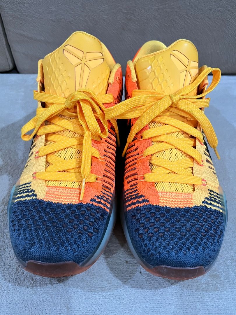 Nike Kobe 10 Elite Chester Rivalry (Category: Sneakers) located in Marikina City. Submitted by ronisgaragesale (Listing ID 1426694762, Image 2). Description: Authentic 100%. Bought and used by my husband in the US. No box. Nike Kobe X Elite Low in University Gold colorway. Features a yellow and orange knit upper with a black swoosh. The outsole is translucent orange. The size tag indicates a US size 10, UK 9, and EUR 44. Made in China..
