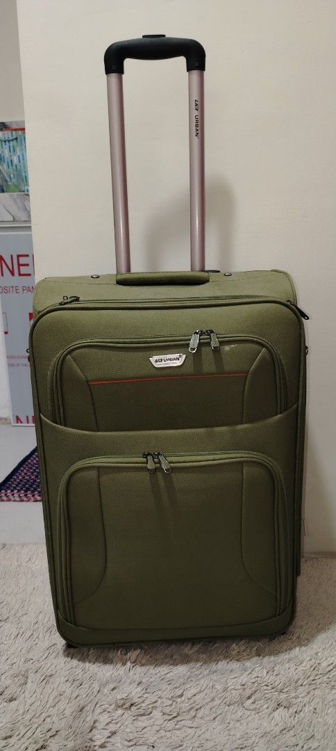 Olive Green Rolling Luggage (Category: Luggage) located in Manila. Submitted by tanyadeguzman (Listing ID 1426655680, Image 2). Description: Durable olive green rolling luggage with a retractable handle. Features multiple zippered compartments for organized packing. Includes a combination lock for added security. The interior is lined with a patterned fabric and has a small pocket. It has wheels for easy transport. The luggage has a handle on the