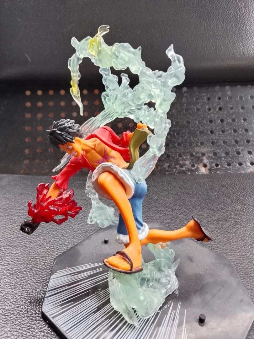 One Piece Luffy Gear 4 Figure (Category: Figurines & Statues) located in Davao. Submitted by Ysang40 (Listing ID 1426762993, Image 2). Description: One Piece figure features Luffy in his Gear 4 form. The figure is dynamically posed with translucent energy effects. Luffy is wearing his signature red shirt, blue shorts, and sandals. The base is a black hexagonal shape with white lines..