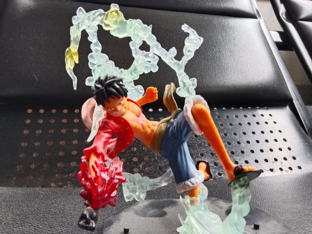 One Piece Luffy Gear 4 Figure (Category: Figurines & Statues) located in Davao. Submitted by Ysang40 (Listing ID 1426762993, Image 1). Description: One Piece figure features Luffy in his Gear 4 form. The figure is dynamically posed with translucent energy effects. Luffy is wearing his signature red shirt, blue shorts, and sandals. The base is a black hexagonal shape with white lines..