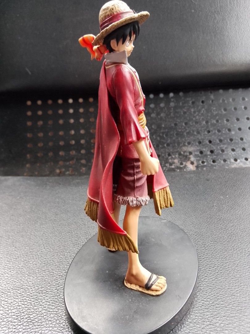 One Piece Monkey D. Luffy Figure (Category: Figurines & Statues) located in Davao. Submitted by Ysang40 (Listing ID 1426763614, Image 3). Description: One Piece figure features Monkey D. Luffy in a red outfit with a straw hat. The figure is standing on a black base. The cape has a Jolly Roger design. The figure is made in China..
