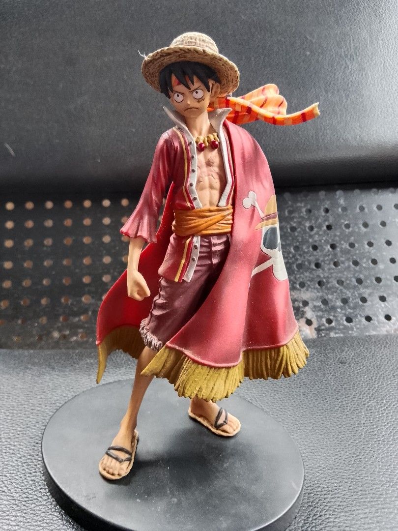 One Piece Monkey D. Luffy Figure (Category: Figurines & Statues) located in Davao. Submitted by Ysang40 (Listing ID 1426763614, Image 1). Description: One Piece figure features Monkey D. Luffy in a red outfit with a straw hat. The figure is standing on a black base. The cape has a Jolly Roger design. The figure is made in China..
