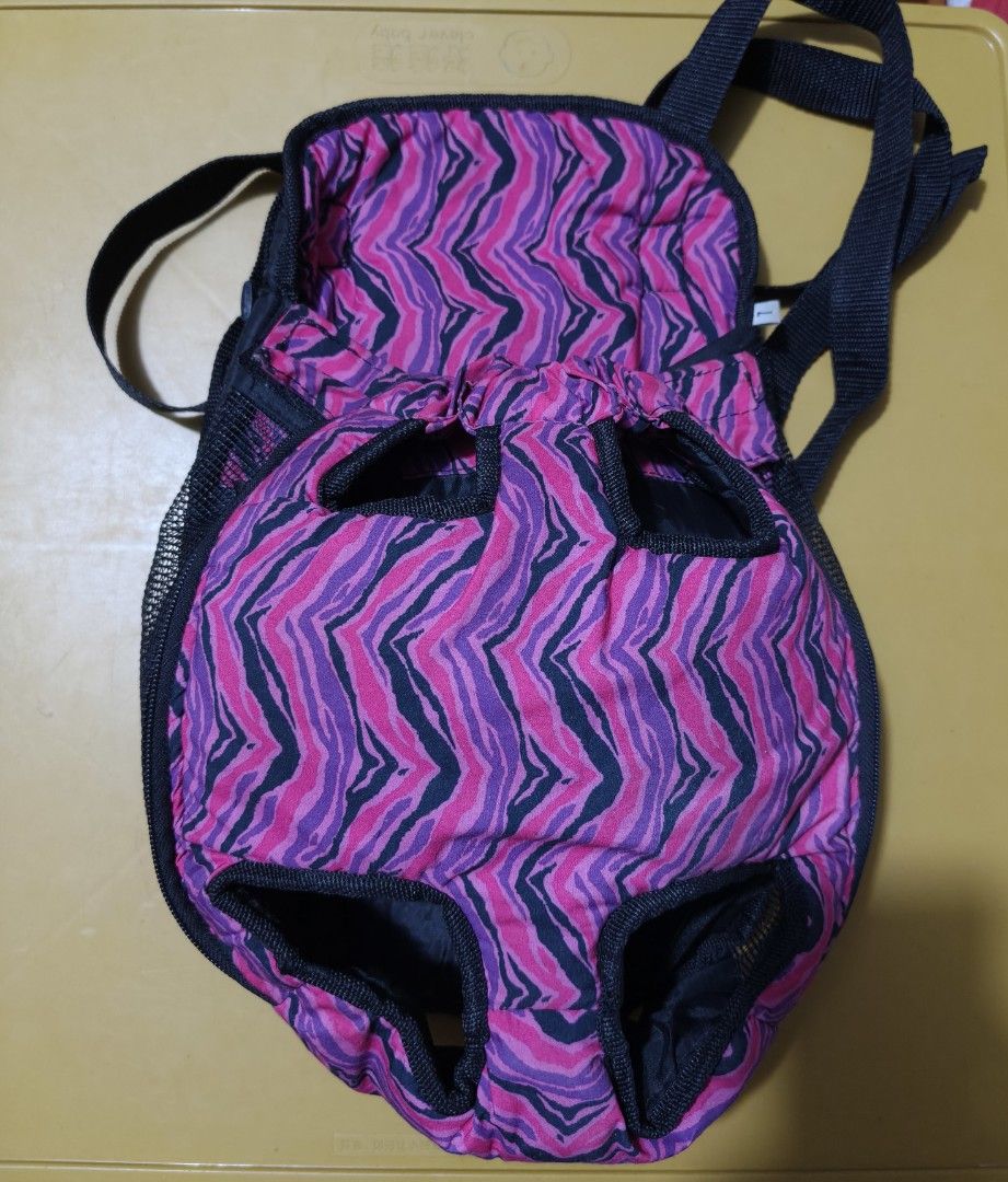 Pet Carrier Backpack - Pink Zebra Print (Category: Homes & Other Pet Accessories) located in Manila. Submitted by anneesp (Listing ID 1426660582, Image 1). Description: Pet carrier backpack features a vibrant pink and purple zebra print. It has openings for the pet's legs and head. The back of the carrier is black with adjustable straps. It also has a mesh side for ventilation. Perfect for carrying small pets comfortably and securely. #petcarrier
