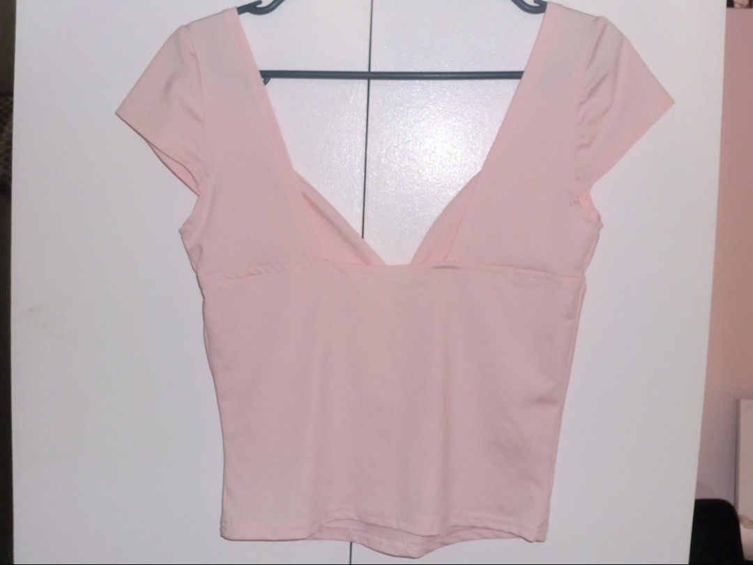 pink short sleeve low cut deep v-neck top (Category: Blouses) located in Bulacan. Submitted by bellisimiu (Listing ID 1426688537, Image 2). Description: bought it from the orange app 🌟 - color is a bit neon-ish - haven’t worn it.