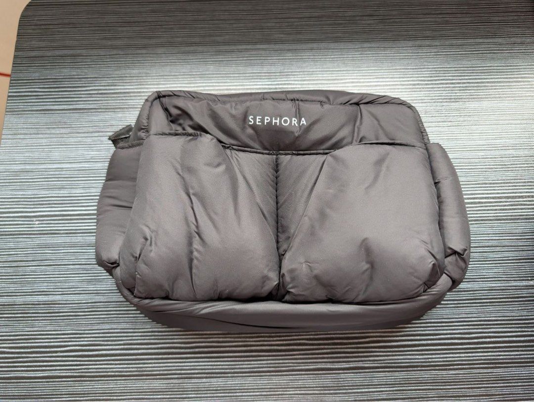 Sephora Puffer Cosmetic Toiletry Bag (Category: Makeup) located in Manila. Submitted by cavemandraws (Listing ID 1426674803, Image 1). Description: Sephora cosmetic bag is a stylish and practical accessory. It features a padded design and a zippered closure. The bag has a main compartment and a side pocket. It is perfect for storing makeup, skincare products, or other small essentials. The bag is compact and easy to carry..