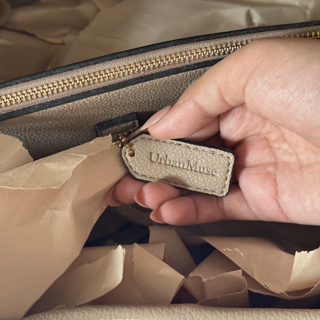 Urban Muse Shej Maxi Tote Bag (Category: Tote Bags) located in Quezon City. Submitted by aligatsss (Listing ID 1426690840, Image 3). Description: Color: Taupe. Great for office. Almost brand new Comes with strap, dust bag, and plastic. RFS: It doesn’t fit my 15’ macbook but it can fit a 13’ laptop. Similar style to cch lana Original price is ₱2,799 Mode of shipment is through SAME DAY DELIVERIES ONLY for this Item..