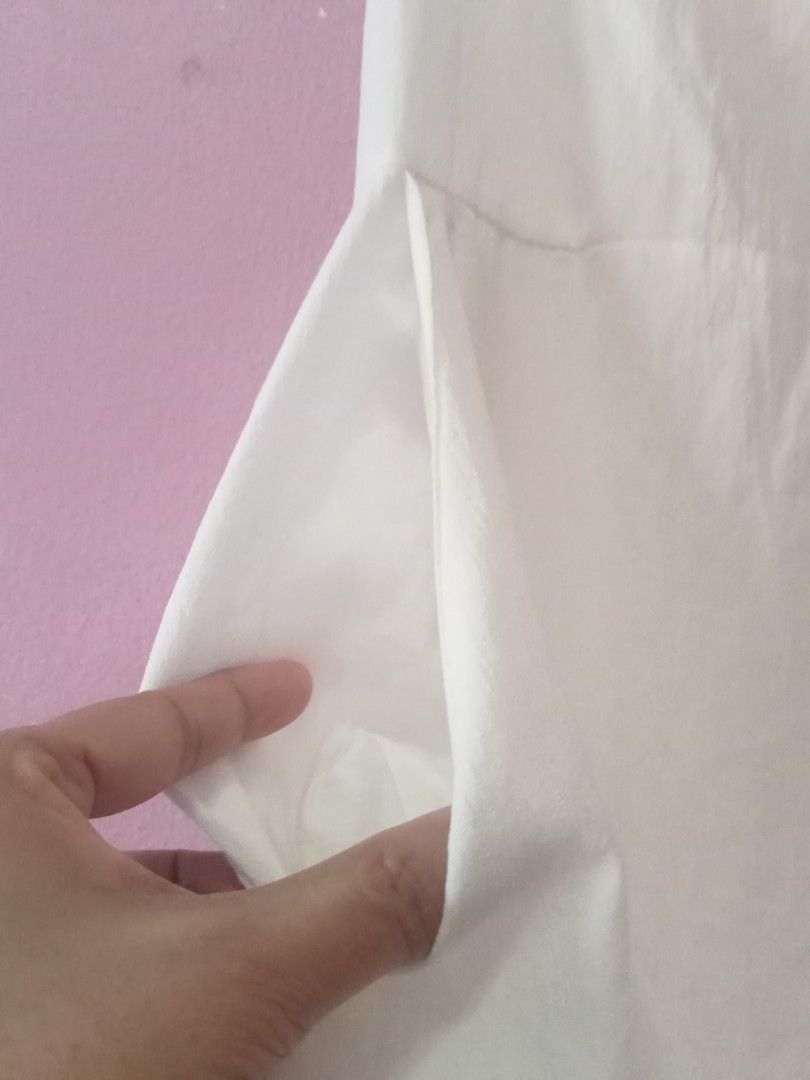 White Midi Dress with Ruffle Sleeves (Category: Dresses) located in Bulacan. Submitted by fujikko (Listing ID 1426756437, Image 3). Description: Elegant white midi dress featuring ruffle sleeves and a sweetheart neckline. The dress has a fitted bodice with smocking details and a flared skirt. It also has pockets. Perfect for a casual day out or a special occasion. Made from a lightweight fabric, it offers a comfortable fit..