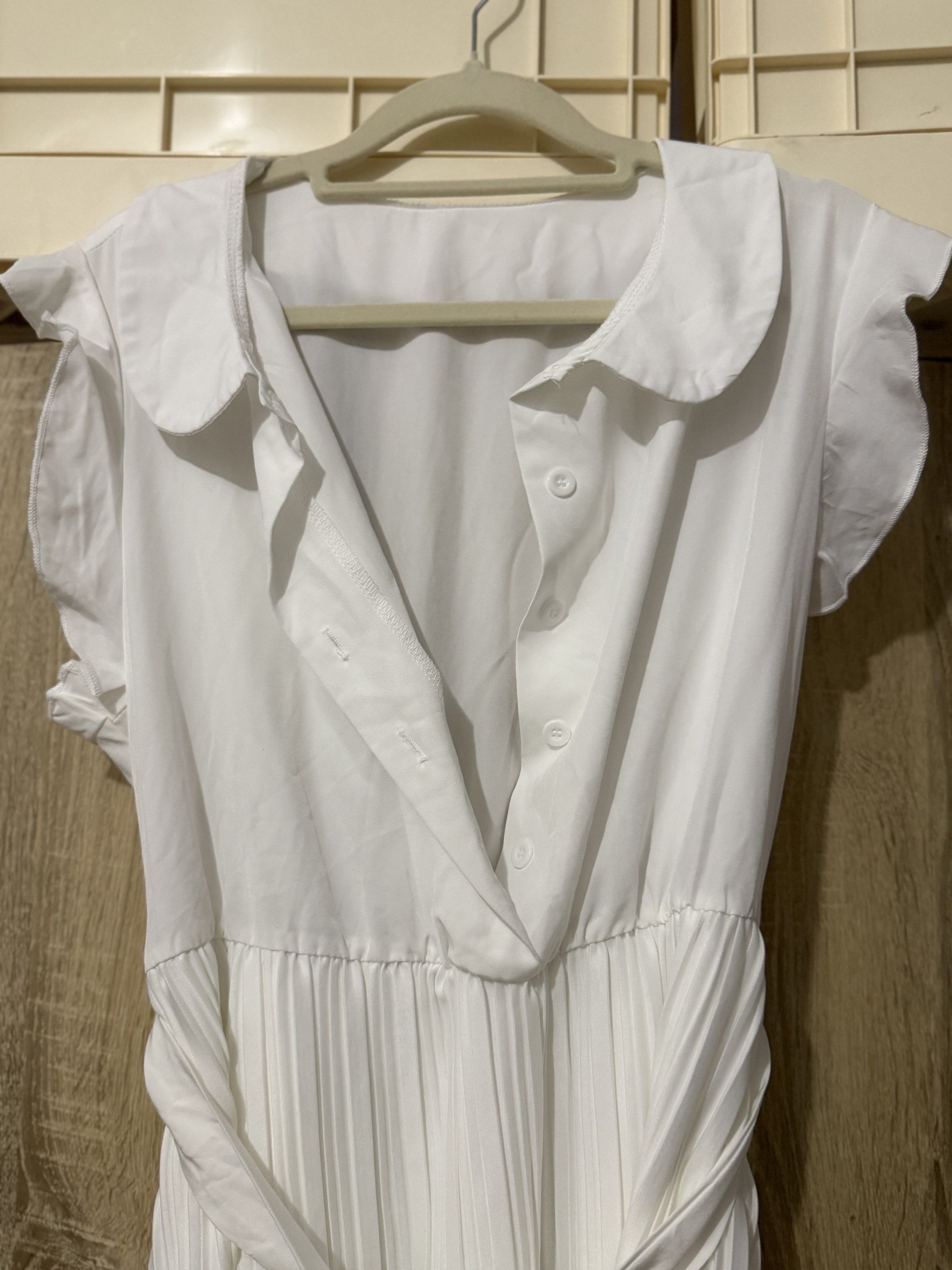 White Pleated Dress with Belt (Category: Dresses) located in Cebu City. Submitted by xishy (Listing ID 1426649078, Image 2). Description: Elegant white dress featuring a pleated skirt and a collared neckline. It has short sleeves and a belt with a gold-colored buckle to cinch the waist. The dress has a button-down front and a flattering silhouette. Perfect for a variety of occasions..