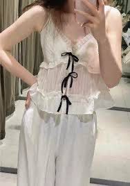 Zara M - white ruffled camisole top (Category: Sleeveless) located in Pasay City. Submitted by ella8922 (Listing ID 1426757201, Image 2). Description: -white ruffled camisole top -spaghetti straps and a tie front.