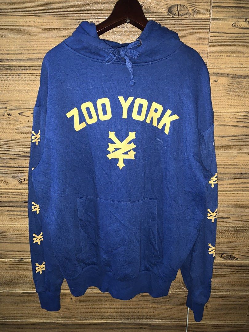 Zoo York Hoodie (Category: Hoodies) located in Valenzuela. Submitted by Caloooy (Listing ID 1426742585, Image 1). Description: Blue Zoo York hoodie with yellow logo and sleeve details. Features a drawstring hood and a kangaroo pocket. The size is M/M. The hoodie has the Zoo York logo on the front and the sleeves. 600+sf.