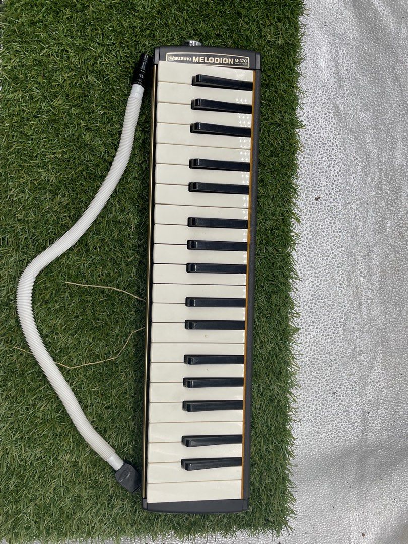 37 keys Suzuki (Category: Musical Instruments) located in Quezon City. Submitted by eilgaraje (Listing ID 1426857404, Image 1). Description: Suzuki Melodion M-37C with a white tube and carrying case. The melodion has black and white keys. The case is black with a handle. Made in Japan. Includes a sticker with a rabbit on the case. Japan surplus almost good condition Yes tested ok Bag included.