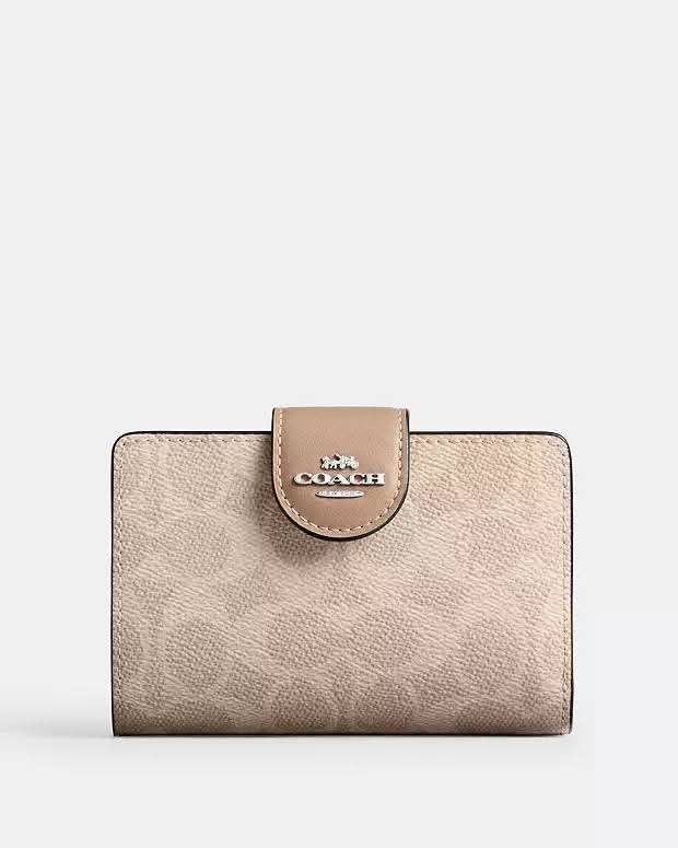 Authentic Coach Signature Snap Wallet (Category: Luxury Bags & Wallets) located in Davao. Submitted by gatrading (Listing ID 1426830475, Image 1). Description: Coach wallet features a signature pattern and a snap closure. The wallet has a neutral color scheme with a flap that has the Coach logo. The design is classic and suitable for everyday use..