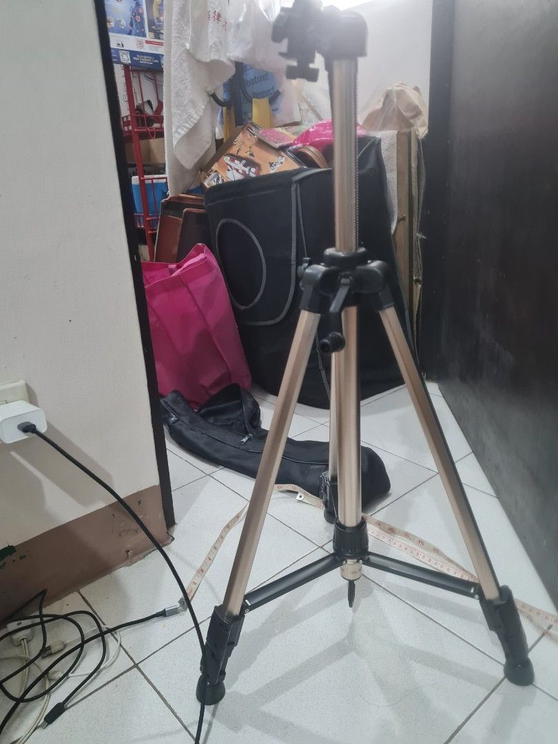 Camera Tripod with Carrying Bag (Category: Tripods & Monopods) located in Quezon City. Submitted by declutter1990 (Listing ID 1426815279, Image 3). Description: Tripod is designed for stability and ease of use. It features adjustable legs and a mounting head for cameras. Includes a carrying bag for convenient transport and storage..