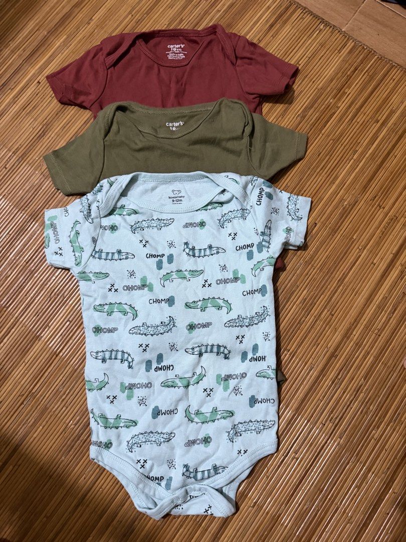Carter's Baby Clothes Set (Category: Babies & Kids Fashion) located in Mandaluyong City. Submitted by jenvm (Listing ID 1426831356, Image 2). Description: Baby clothes set includes several Carter's bodysuits and a shorts set. The bodysuits come in various colors and patterns, including a crocodile print. The shorts set features an orange shirt with a dinosaur wearing sunglasses and gray shorts. The set is suitable for babies..