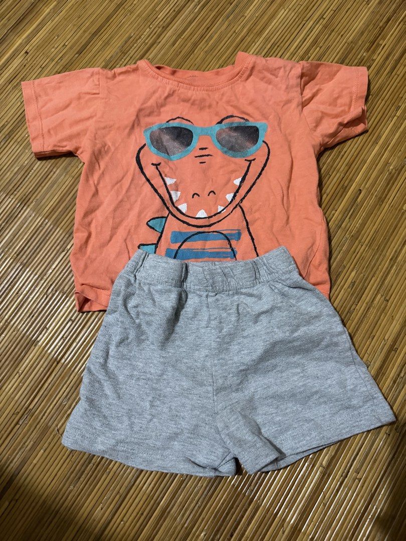 Carter's Baby Clothes Set (Category: Babies & Kids Fashion) located in Mandaluyong City. Submitted by jenvm (Listing ID 1426831356, Image 3). Description: Baby clothes set includes several Carter's bodysuits and a shorts set. The bodysuits come in various colors and patterns, including a crocodile print. The shorts set features an orange shirt with a dinosaur wearing sunglasses and gray shorts. The set is suitable for babies..