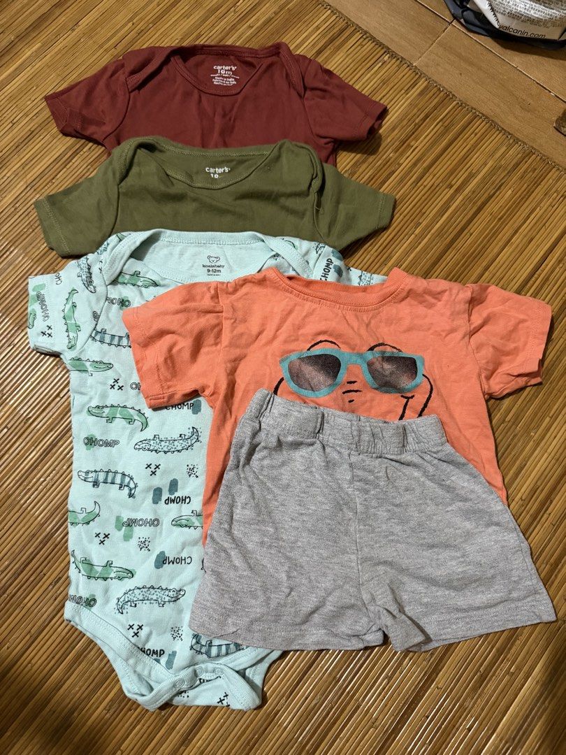 Carter's Baby Clothes Set (Category: Babies & Kids Fashion) located in Mandaluyong City. Submitted by jenvm (Listing ID 1426831356, Image 1). Description: Baby clothes set includes several Carter's bodysuits and a shorts set. The bodysuits come in various colors and patterns, including a crocodile print. The shorts set features an orange shirt with a dinosaur wearing sunglasses and gray shorts. The set is suitable for babies..