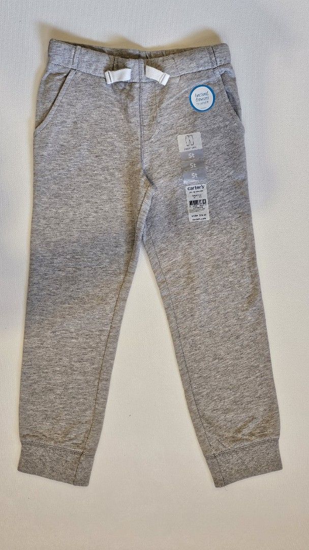 Carter's Toddler Jogger Pants 5T (Category: Babies & Kids Fashion) located in Quezon. Submitted by cgmhe (Listing ID 1426872481, Image 1). Description: Carter's toddler sweatpants in size 5T. Features a drawstring waist and two front pockets. Made of 100% cotton. The pants are gray in color. The tag indicates the item is made in Vietnam..