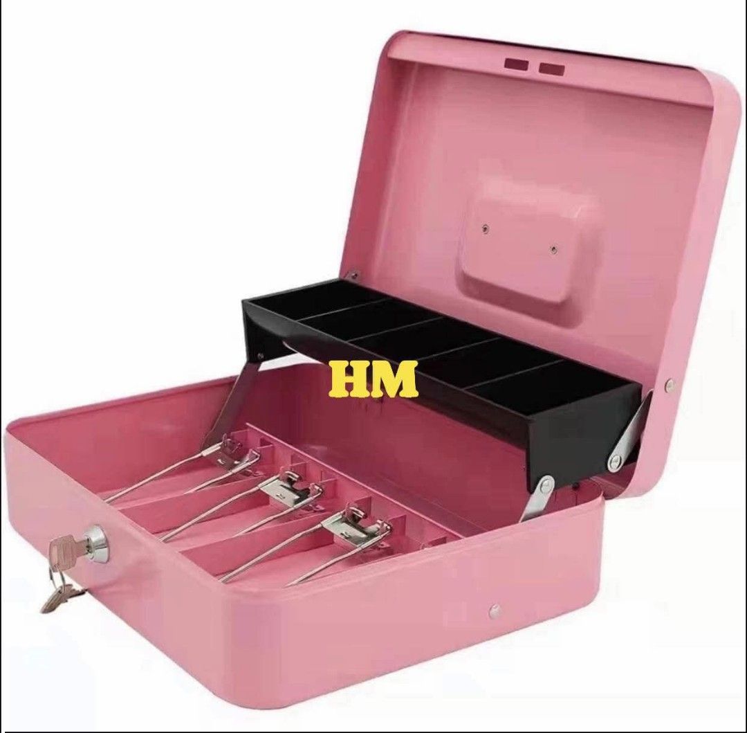Cash Box (Category: Storage Boxes & Baskets) located in Manila. Submitted by jelai.cybyb (Listing ID 1426875119, Image 1). Description: Cash box is available in pink, blue, red, and black. It features a removable tray for organizing bills and coins. The box includes a lock and key for security. It is ideal for small businesses, personal use, or as a gift. The cash box is compact and easy to carry..