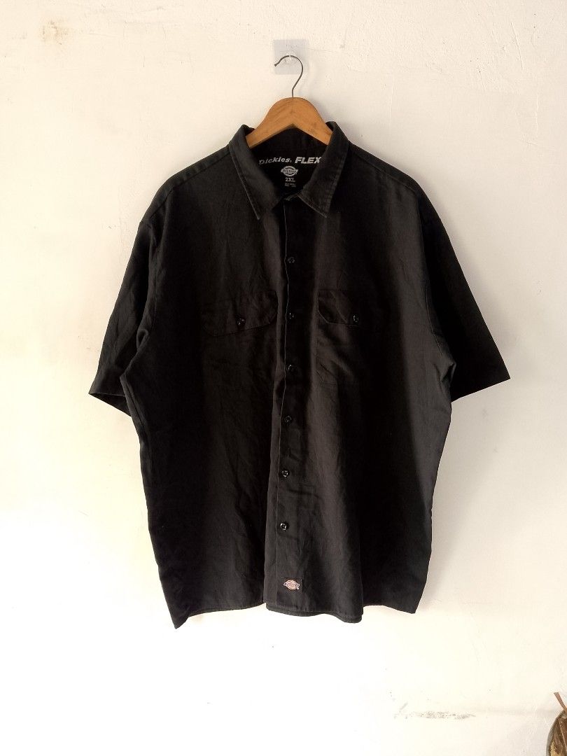 Dickies Flex Short Sleeve Shirt 2XL (Category: Tshirts & Polo Shirts ) located in Santa Cruz. Submitted by extrainchukay (Listing ID 1426914596, Image 1). Description: Black Dickies Flex short sleeve shirt. Features a button-down front and two chest pockets. The shirt is size 2XL and made in Honduras. The Dickies logo is visible on the collar and near the hem..