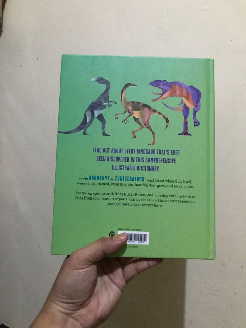Dictionary of Dinosaurs Book (Category: Children's Books) located in Dumarao. Submitted by mellowbabe23 (Listing ID 1426897530, Image 2). Description: Book is a dictionary of dinosaurs, featuring an illustrated A to Z of every dinosaur ever discovered. It contains over 300 dinosaurs. The book has a green cover with various dinosaur illustrations. It has a price tag of £7, with offers for multiple purchases..