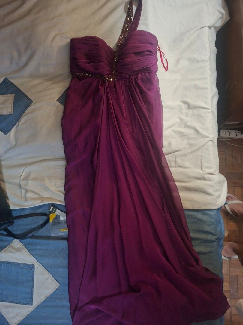 Elegant Purple One-Shoulder Gown (Category: Evening dresses & gowns) located in Paranaque City. Submitted by pormakaday (Listing ID 1426805309, Image 3). Description: Stunning purple one-shoulder gown. Features a draped bodice with delicate beading and a flowing, floor-length skirt. The dress has a flattering silhouette and is perfect for special occasions. The strap is also embellished with beads. Made of a soft, flowing fabric..