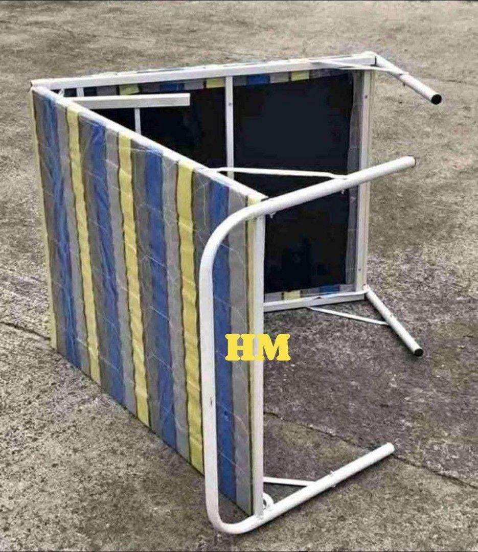 Folding Bed (Category: Bed Frames & Mattresses) located in Manila. Submitted by jelai.cybyb (Listing ID 1426875427, Image 1). Description: Folding bed features a mattress with a striped pattern. It has a white metal frame. The bed can be folded for easy storage. It is suitable for guest rooms or small spaces. The bed is designed for comfort and convenience..