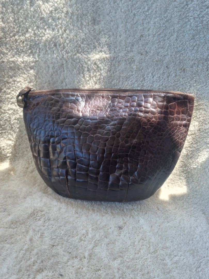 Furla Brown Crocodile Clutch (Category: Luxury Bags & Wallets) located in Baguio. Submitted by hirayadg32419 (Listing ID 1426825882, Image 1). Description: Furla clutch features a brown crocodile-embossed exterior. It has a zipper closure and a small interior pocket. The interior lining is a light brown suede. The zipper pull has an "Italy" tag..