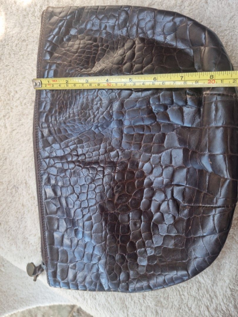 Furla Brown Crocodile Clutch (Category: Luxury Bags & Wallets) located in Baguio. Submitted by hirayadg32419 (Listing ID 1426825882, Image 2). Description: Furla clutch features a brown crocodile-embossed exterior. It has a zipper closure and a small interior pocket. The interior lining is a light brown suede. The zipper pull has an "Italy" tag..