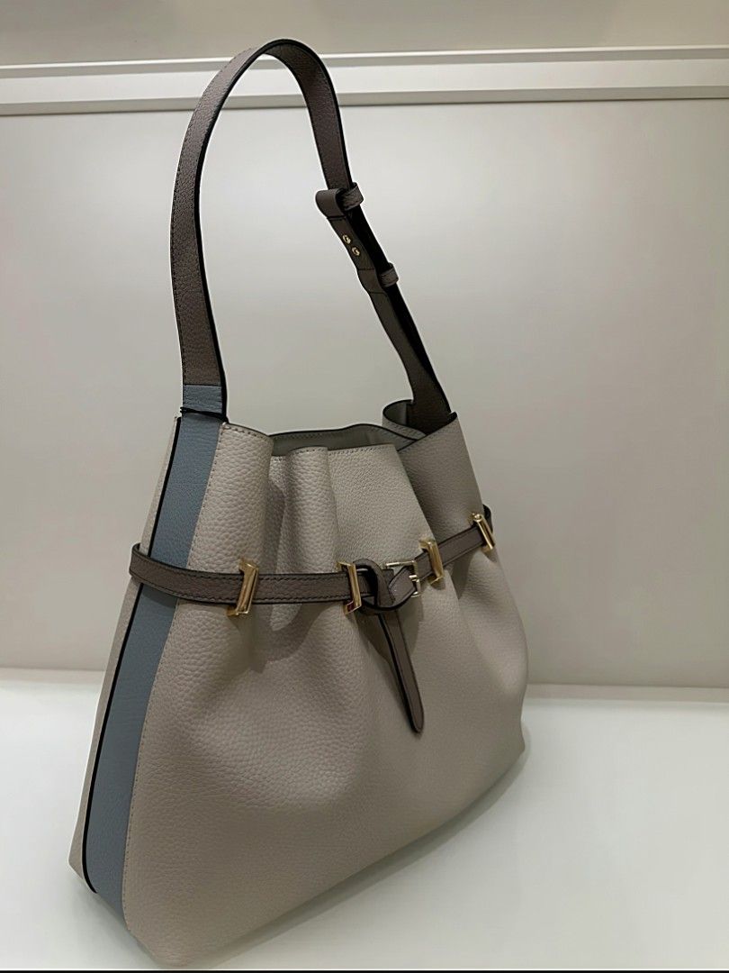 Furla Bucket Bag with Shoulder Strap (Category: Luxury Bags & Wallets) located in Las Pinas. Submitted by ajbash (Listing ID 1426871861, Image 1). Description: Elegant Furla bucket bag. Features a neutral color with a blue stripe detail and gold-tone hardware. Includes a shoulder strap. Comes with original tags and dust bag. Perfect for everyday use or special occasions. A stylish and versatile addition to any wardrobe..