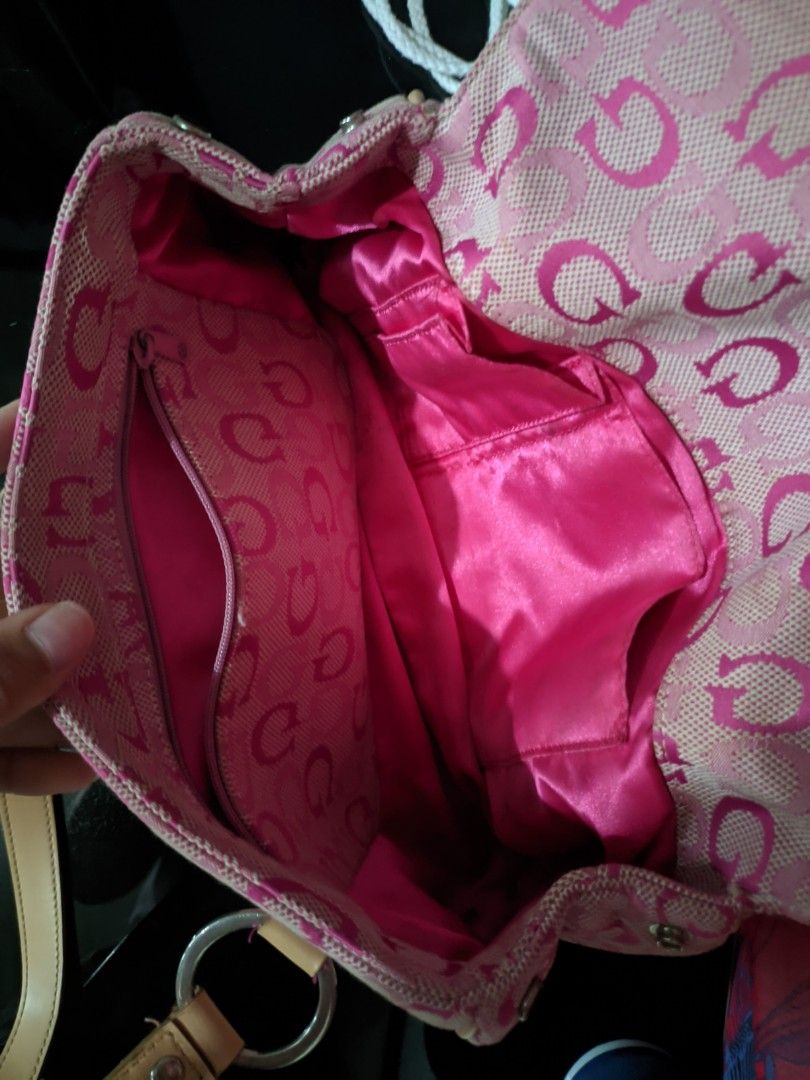 Vintage bag Guess Pink (Category: Luxury Bags & Wallets) located in Manila. Submitted by happydragon.eb63f5 (Listing ID 1426811061, Image 2). Description: Pink Guess handbag with a repeating 'G' pattern. Features a top handle design with beige leather straps and silver hardware. Includes a front zipper pocket and a main compartment with a pink satin lining. The bag has a magnetic clasp closure. The interior has a pocket with the 'G' pattern..