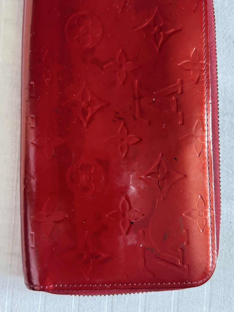 Louis Vuitton Vernis Zippy Wallet (Category: Luxury Bags & Wallets) located in Quezon City. Submitted by marymae1223 (Listing ID 1426811869, Image 3). Description: Authentic Louis Vuitton Zippy Wallet in red vernis leather. Features the iconic LV monogram pattern. The wallet has a zip-around closure and a gold-tone zipper. The interior includes multiple card slots, compartments, and a zippered coin pocket. Includes a receipt from Citibank bought 