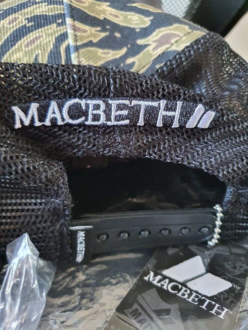 Macbeth Camo Trucker Cap (Category: Caps & Hats) located in Meycauayan. Submitted by shoptoown (Listing ID 1426878776, Image 2). Description: Macbeth cap features a unique camo pattern. It has a mesh back for breathability and an adjustable snapback closure. The Macbeth logo is visible on the side and inside the cap..