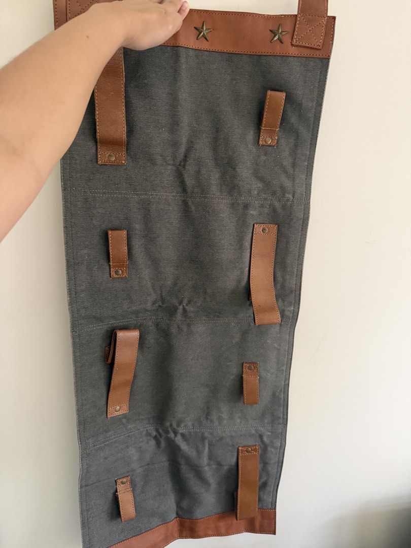 Mona B 4-Pocket Wine Rack (Category: Other Kitchenware & Tableware) located in Taguig. Submitted by jmarieb_09 (Listing ID 1426828836, Image 2). Description: Mona B wine rack - gray canvas body with brown leather accents. Has 4 pockets for wine bottles and leather straps with metal button closures. Dimensions Length - 34 inches Width - 15 inches Gifted, stored only.