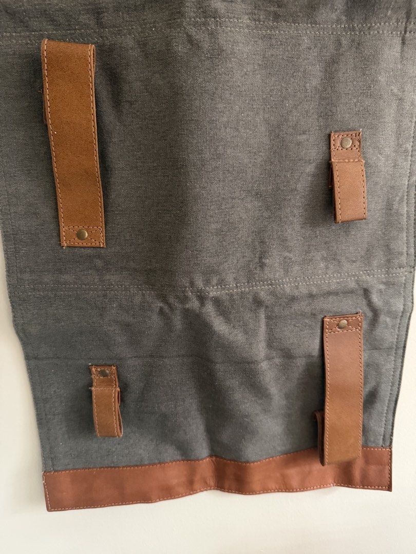 Mona B 4-Pocket Wine Rack (Category: Other Kitchenware & Tableware) located in Taguig. Submitted by jmarieb_09 (Listing ID 1426828836, Image 1). Description: Mona B wine rack - gray canvas body with brown leather accents. Has 4 pockets for wine bottles and leather straps with metal button closures. Dimensions Length - 34 inches Width - 15 inches Gifted, stored only.