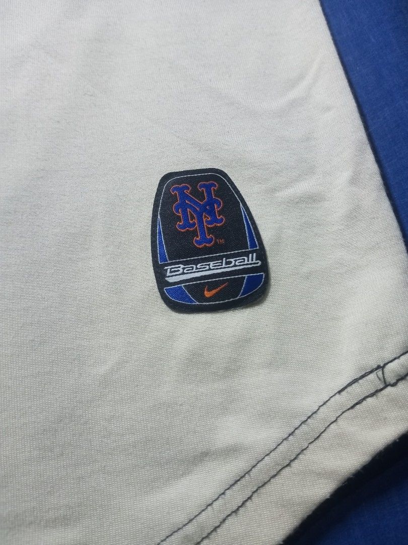 Nike New York Mets Baseball Jersey (Category: Tshirts & Polo Shirts ) located in Davao. Submitted by lordpabito71094 (Listing ID 1426872710, Image 3). Description: Authentic Nike baseball jersey featuring the New York Mets. The jersey has a white body with black sleeves and blue accents. The Mets logo is prominently displayed on the front, and the Nike logo is visible. The back of the jersey features the Mets logo. Made in Indonesia..