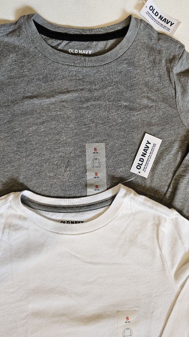 Old Navy Long Sleeve Shirt (Size S) 2pcs (Category: Babies & Kids Fashion) located in Quezon. Submitted by cgmhe (Listing ID 1426873806, Image 2). Description: Two Old Navy long sleeve shirts. One is gray, and the other is white. Both shirts have a crew neck. The size is S (6-7). Made in Vietnam. The shirts have the original tags attached. 2pcs for 380.