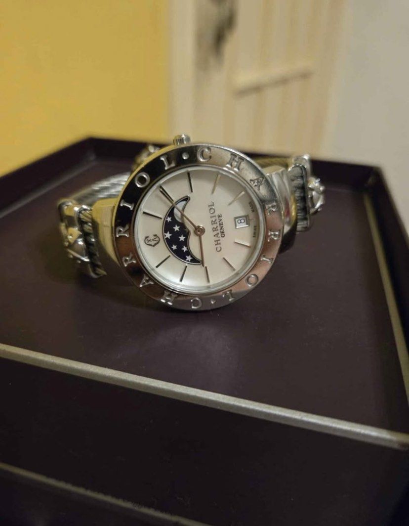 Original Charriol St-Tropez Moonphase Watch⌚️ (Category: Luxury Watches) located in Manila. Submitted by luxurycollectionhouse (Listing ID 1426880243, Image 2). Description: Elegant Charriol St-Tropez watch featuring a moonphase dial. The watch has a stainless steel cable bracelet and a silver-tone case. Includes original box and papers. The watch has Roman numeral hour markers and a date display. The watch is a stylish accessory for any occasion