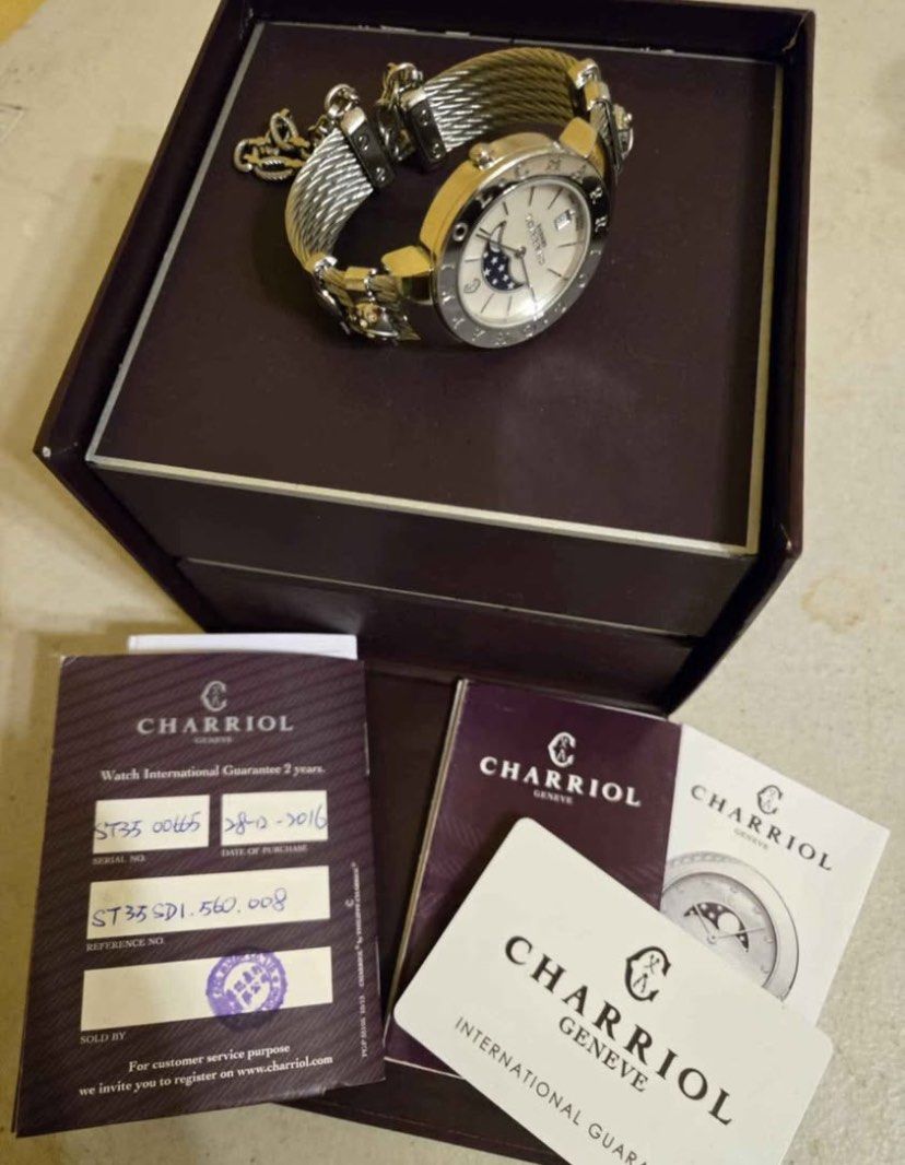Original Charriol St-Tropez Moonphase Watch⌚️ (Category: Luxury Watches) located in Manila. Submitted by luxurycollectionhouse (Listing ID 1426880243, Image 1). Description: Elegant Charriol St-Tropez watch featuring a moonphase dial. The watch has a stainless steel cable bracelet and a silver-tone case. Includes original box and papers. The watch has Roman numeral hour markers and a date display. The watch is a stylish accessory for any occasion
