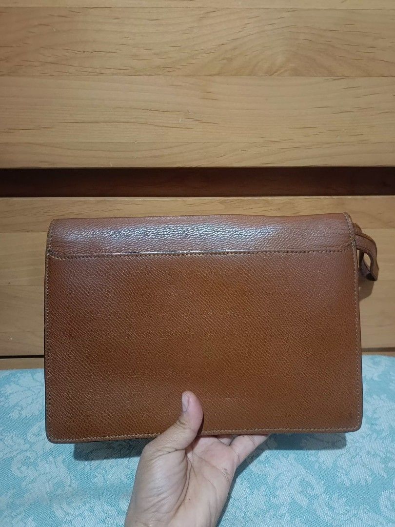 Renoma Clutch Bag (Category: Belt bags, Clutches and Pouches) located in Baguio. Submitted by roselleshiddentreasures13384 (Listing ID 1426834052, Image 2). Description: - Renoma Clutch Bag - Brown color - Textured finish - Gold clasp - Wrist strap - Stylish and functional.