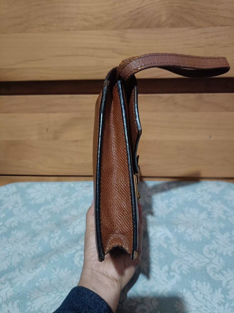 Renoma Clutch Bag (Category: Belt bags, Clutches and Pouches) located in Baguio. Submitted by roselleshiddentreasures13384 (Listing ID 1426834052, Image 3). Description: - Renoma Clutch Bag - Brown color - Textured finish - Gold clasp - Wrist strap - Stylish and functional.