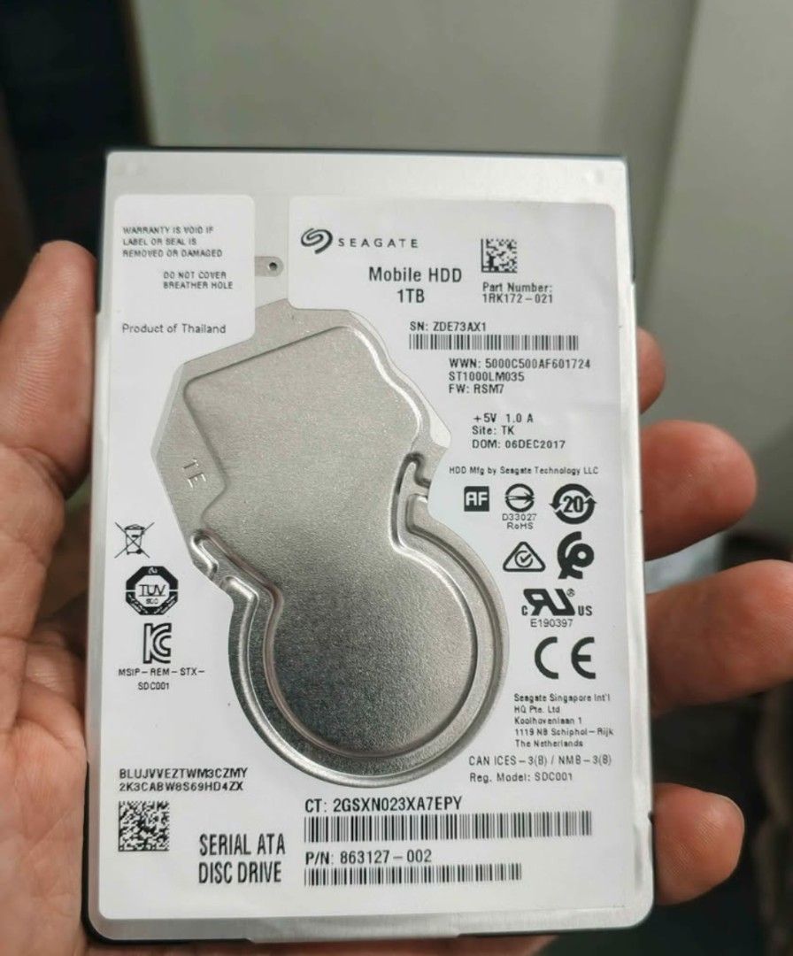 Slimtype Seagate Mobile HDD 1TB (Category: Hard Disks & Thumbdrives) located in Quezon City. Submitted by gadgetsun (Listing ID 1426886805, Image 1). Description: Seagate Mobile HDD with 1TB storage capacity. Features a Serial ATA Disc Drive interface. Manufactured by Seagate Singapore Technology LLC. Includes the following certifications: AF, RoHS, CE, and others. Part number is 1RK172-821. Model number is ZDE73AX1. DOM is 06DEC2017..