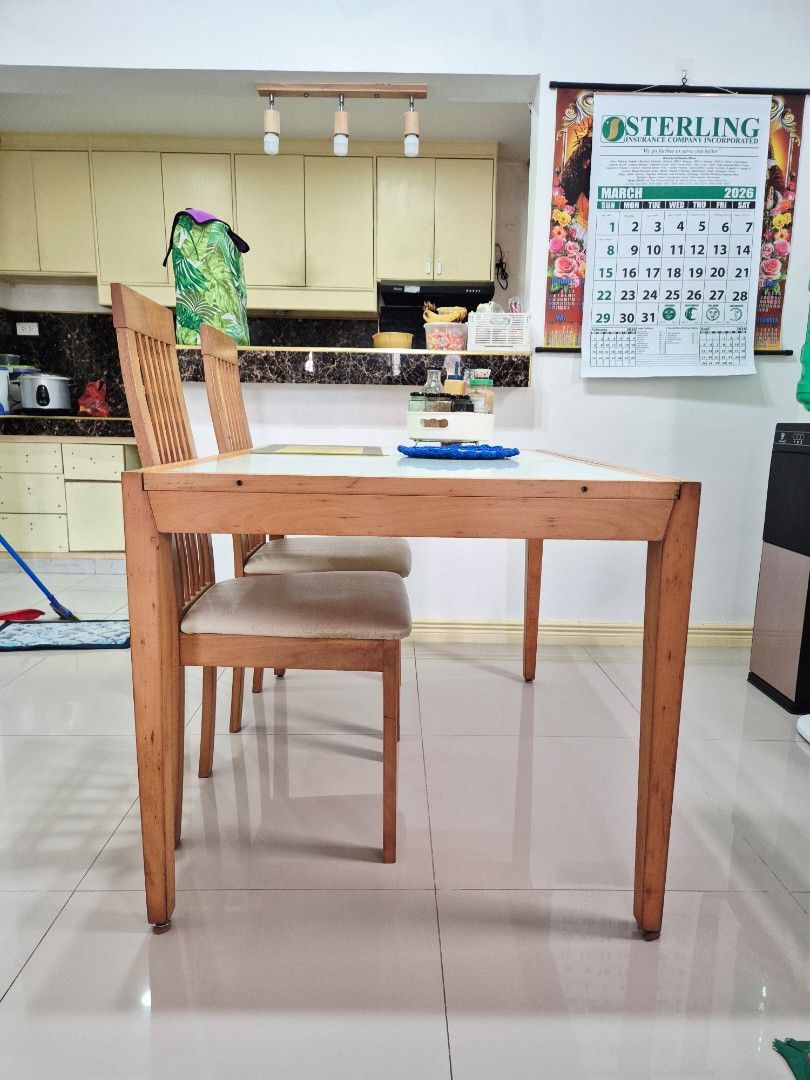 Solid Wood Expandable Dining Table with 4 Chairs (Category: Tables & Sets) located in Quezon City. Submitted by khristinellanes (Listing ID 1426937097, Image 1). Description: Expandable solid wood dining set with a tempered glass top and 4 matching chairs. The chairs have a lattice back design and cushioned seats. The table has a light wood finish. Issue: Need to repaint yung foot ng table and chairs..