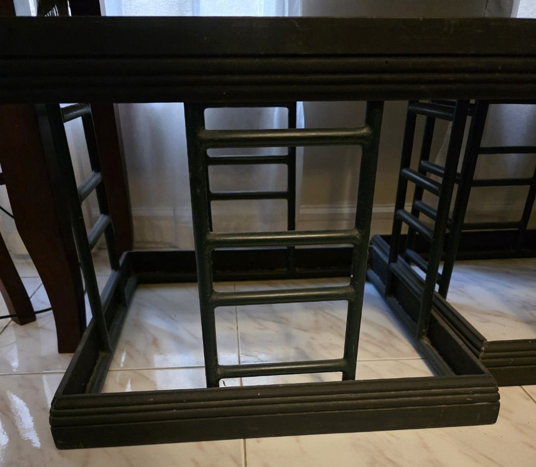 Square Side Tables (Category: Tables & Sets) located in Manila. Submitted by tresmmm (Listing ID 1426836533, Image 2). Description: Set of two square side tables. Features a black frame with a glass top. The frame has a unique ladder-like design in dark green. Perfect for living rooms or bedrooms. Sturdy and stylish, these tables offer a modern touch to any space. Ideal for placing drinks, books, or decorative items. Durable and heavy. measures 5