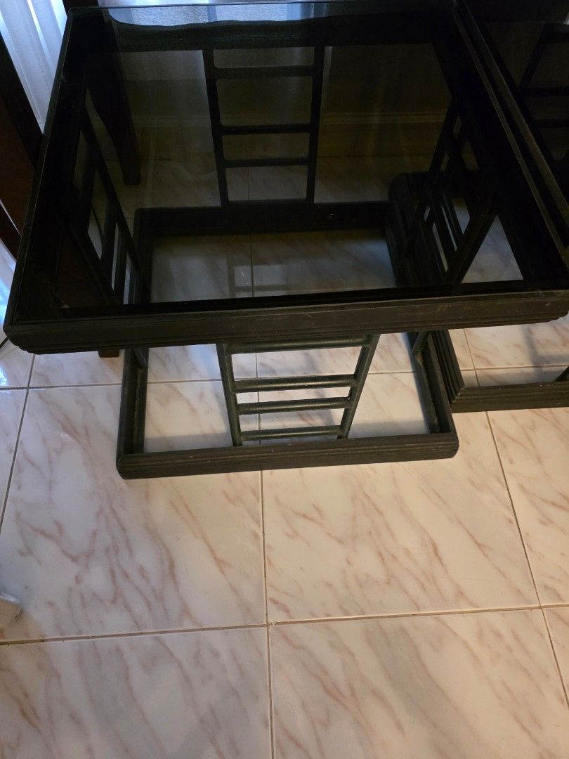 Square Side Tables (Category: Tables & Sets) located in Manila. Submitted by tresmmm (Listing ID 1426836533, Image 3). Description: Set of two square side tables. Features a black frame with a glass top. The frame has a unique ladder-like design in dark green. Perfect for living rooms or bedrooms. Sturdy and stylish, these tables offer a modern touch to any space. Ideal for placing drinks, books, or decorative items. Durable and heavy. measures 5
