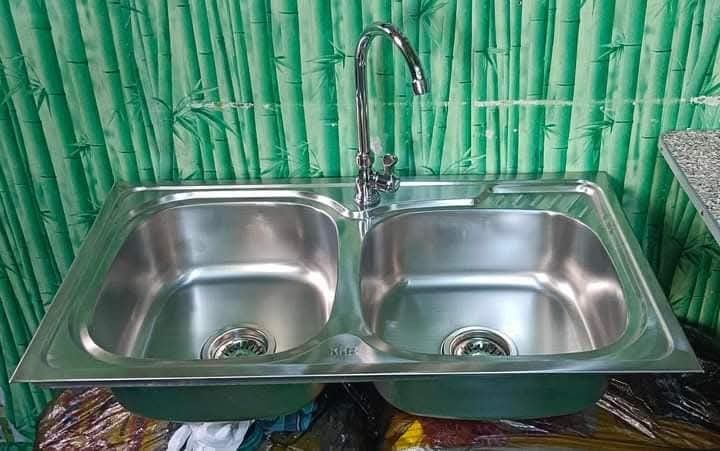 Stainless Steel Double Bowl Kitchen Sink (Category: Bathroom & Kitchen Fixtures) located in Manila. Submitted by muranglababo_ph2026 (Listing ID 1426955852, Image 1). Description: 🛠️ Stainless Double Sink with Faucet – Complete Set! ✨ Bagong-bago, ready to install! 📏 Size: 17 ½ x 31 ½ inches ⬇️ Depth: 6 inches 🚰 Kasama na: faucet at fittings 💰 Presyo: ₱2,200 only! ✅ Matibay at stainless steel – pangmatagalan ✅ Double tub para mas convenient s
