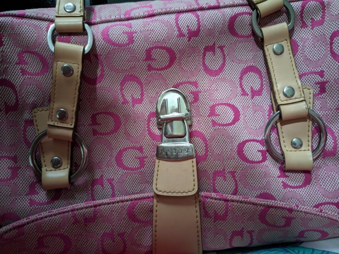 Vintage bag Guess Pink (Category: Luxury Bags & Wallets) located in Manila. Submitted by happydragon.eb63f5 (Listing ID 1426811061, Image 3). Description: Pink Guess handbag with a repeating 'G' pattern. Features a top handle design with beige leather straps and silver hardware. Includes a front zipper pocket and a main compartment with a pink satin lining. The bag has a magnetic clasp closure. The interior has a pocket with the 'G' pattern..